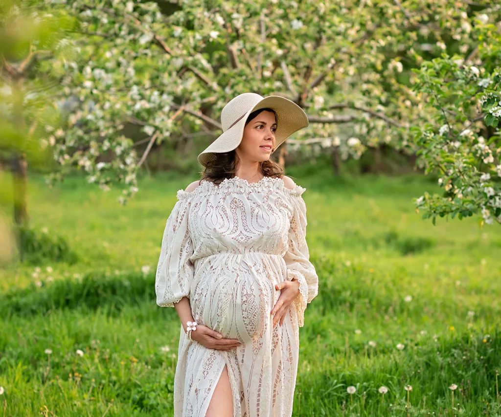 pregnant woman in a blooming orchard